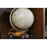 AN ILLUMINATED DESK GLOBE TOGETHER WITH A TREEN MODEL OF A VINTAGE CAR