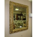 A VINTAGE GILT FRAMED AND MOULDED RECTANGULAR MIRROR 57 X 44 CM