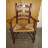 AN ANTIQUE OAK WICKERSEAT ARMCHAIR