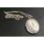 A LARGE HALLMARKED SILVER LOCKET AND CHAIN