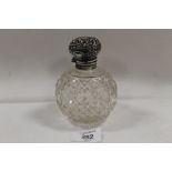 A SILVER MOUNTED SCENT BOTTLE - (STOPPER STUCK)