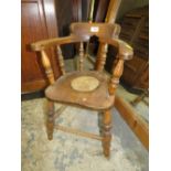 A VINTAGE CHILDS WINDSOR ARMCHAIR WITH HOLE