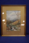 A FRAMED WATERCOLOUR OF A COUNTRYSIDE SCENE SIGNED TO THE LOWER RIGHT