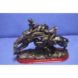 A CARVED RESIN FIGURE OF 2 HORSES AND RIDERS