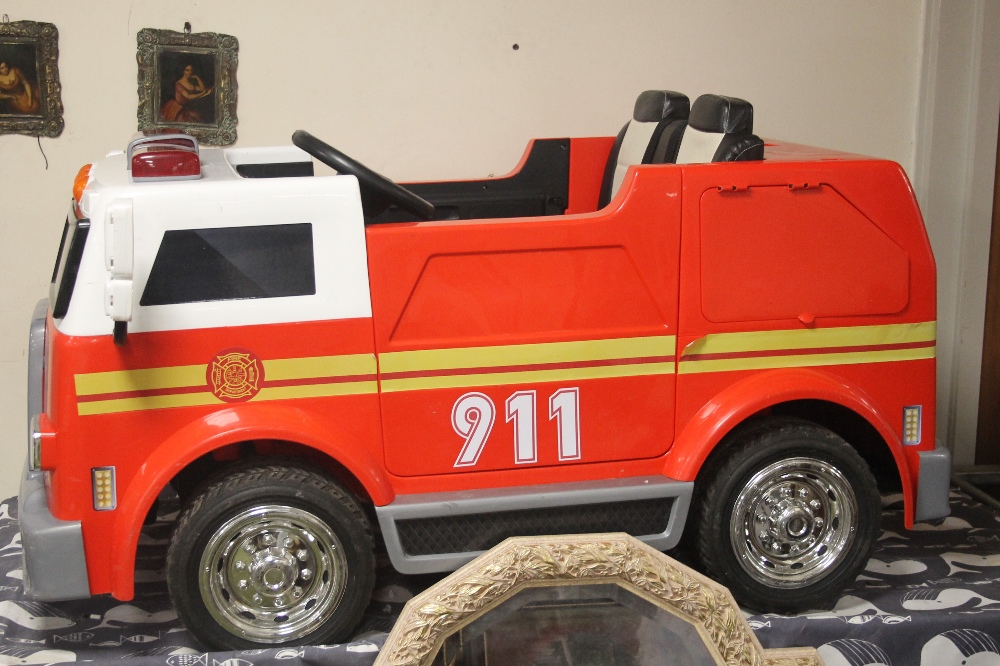 A CHILDS FIRE ENGINE MISSING HEADLIGHT