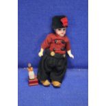 A SMALL ANTIQUE BISQUE HEADED DOLL TOGETHER WITH A SMALL WOODEN FIGURE A/F