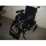 A POWERED WHEELCHAIR WITH CHARGER