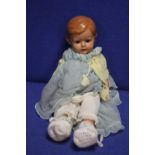 AN ANTIQUE PORCELAIN HEADED DOLL