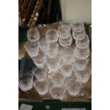 A TRAY OF CUT GLASS DRINKING GLASSES (TRAY NOT INCLUDED)