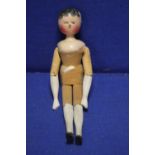 AN ANTIQUE CARVED WOODEN DOLL