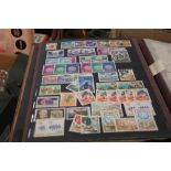 A BOX OF ASSORTED STAMPS IN ALBUMS