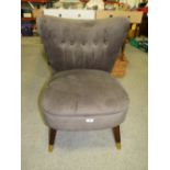 A MODERN UPHOLSTERED TAUPE CHAIR