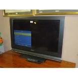 A SONY 31" FLATSCREEN TV - REMOTE