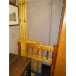 A HONEY PINE PAIR OF SINGLE BED FRAMES