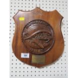 A CARVE WOODEN SHIELD SHAPED PLAQUE PRESENTED BY COMMANDING OFFICER OF USS GRAYBACK