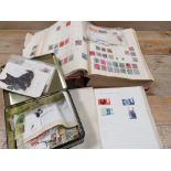 A COLLECTION OF ASSORTED STAMPS CONTAINED IN ALBUMS AND A TIN