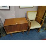 A MID CENTURY TEAK MUSIC CABINET AND ARMCHAIR