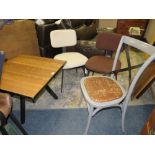 AN INDUSTRIAL STYLE LOW SWIVEL TABLE WITH THREE ASSORTED CHAIRS