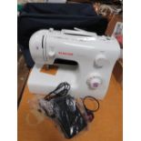 A SINGER TRADITION SEWING MACHINE WITH FABRIC CARRY CASE