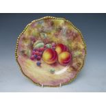 A HAND PAINTED ROYAL WORCESTER CABINET PLATE, still life study of fruit on a mossy bank, by J.