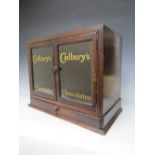 A LATE 19TH / EARLY 20TH CENTURY DISPLAY CABINET, with drawer to base and two glazed doors, the