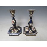 A PAIR OF 18TH CENTURY CONTINENTAL PORCELAIN CANDLESTICKS, decorated with birds and flowers, one