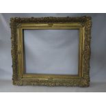 A 19TH CENTURY DECORATIVE GOLD FRAME WITH GOLD SLIP, frame W 12 cm, slip rebate 77 x 64 cm, frame