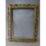 A 19TH CENTURY CARVED WOODEN FLORENTINE GOLD FRAME, frame W 10 cm, rebate 62 x 46 cm