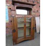 AN EARLY 20TH CENTURY ARTS AND CRAFTS CABINET, having typical copper stylised mounts to the front,