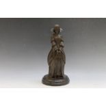 A BRONZE STYLE FIGURE OF A YOUNG LADY HOLDING A BOOK, on a marble base, H 30 cm