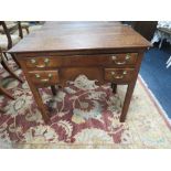A 19TH CENTURY MAHOGANY LOW BOY, the two plank overhung top above a full length single drawer and