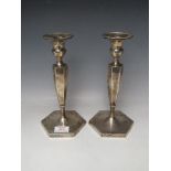 A PAIR OF HALLMARKED SILVER CANDLESTICKS BY HAWKSWORTH EYRE & CO LTD, with Staffordshire