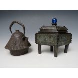 A 20TH CENTURY CAST IRON JAPANESE TEAPOT, together with a brass lozenge shaped casket, the teapot