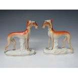 A PAIR OF 19TH CENTURY STAFFORDSHIRE GREYHOUNDS WITH HARES IN THEIR MOUTHS, H 19 cm (2)