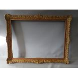 A 19TH CENTURY DECORATIVE GOLD SWEPT FRAME, frame W 6.5 cm, rebate 74 x 54 cm