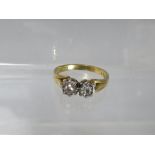 AN 18CT GOLD DRESS RING, with two illusion set diamonds to central crossover type mount, ring size O