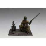 AN AUSTRIAN STYLE COLD PAINTED BRONZE OF AN ARAB GENTLEMAN SEATED ON A CARPET WITH A GUN, W 15 cm