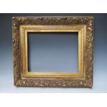 A LATE 18TH / EARLY 19TH CENTURY DECORATIVE GOLD FRAME, with leaf design to outer edge, frame W 11