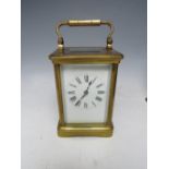 A FRENCH BRASS CARRIAGE CLOCK BY R & Co., white enamel dial and Roman numerals, lever platform