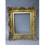 A 19TH CENTURY DECORATIVE GOLD SWEPT FRAME, with gold slip, frame W 10.5 cm, slip rebate 51 x 41 cm,