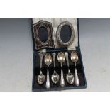 A CASED SET OF HALLMARKED SILVER TEASPOONS - SHEFFIELD 1931, together with two small modern photo