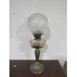 A LATE 19TH CENTURY OIL LAMP, the plated base leading to an etched clear glass reservoir, with