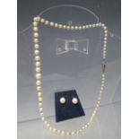 A SINGLE STRAND HAND KNOTTED GRADUATED PEARL NECKLACE WITH 9CT WHITE GOLD CLASP, the clasp set