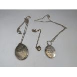 TWO OVAL SILVER PENDANT LOCKETS ON CHAINS, together with a smaller heart shaped example (3)
