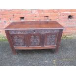 AN EARLY CARVED OAK THREE PANEL COFFER, raised on stile feet, H 62 cm, W 104 cm