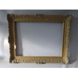 A LATE 19TH / EARLY 20TH CENTURY DECORATIVE SWEPT GOLD FRAME, frame W 9 cm, rebate 62 x 47 cm