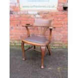 AN EARLY 20TH CENTURY OAK OFFICE ARMCHAIR, with upholstered seat, raised on cabriole supports