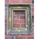 A LATE 18TH / EARLY 19TH CENTURY DECORATIVE GOLD FRAME, with corner embellishments and gold slip, in