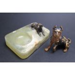 A SMALL COLD PAINTED DOG ON AN ONYX DISH, together with another dog, H 6 cm (2)