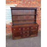 AN 18TH CENTURY OAK WELSH DRESSER, the base with an arrangement of five drawers and two cupboards,